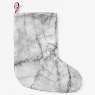 Pattern on the white marble floor texture and back small christmas stocking