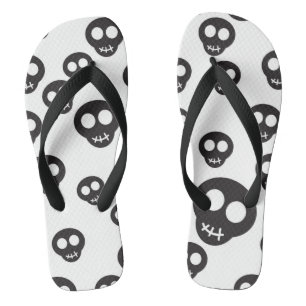 Pattern with black skulls on white flip flops