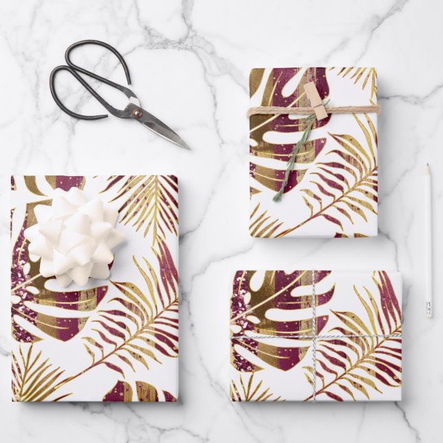 Patterned tropical leaves burgundy and gold wrapping paper sheet (Front)