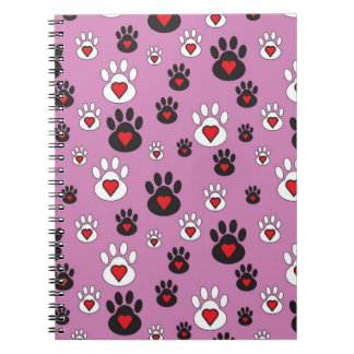 Paw prints with red hearts on pink notebook