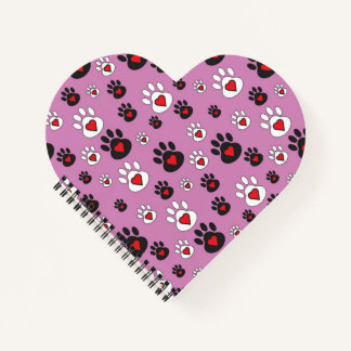 Paw prints with red hearts on pink notebook