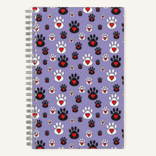 Pawprints with red hearts on blue notebook