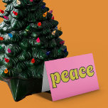 Peace Retro Pink and Lime Green Holiday Card<br><div class="desc">This retro style card features the message "Peace" on the front in lime green letters against a pink background. The inside message can be customised with your own greeting.</div>