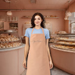 peach fuzz colour -elegant script  apron<br><div class="desc">Peach fuzz colour (#ffbe98) ) solid colour all-over print apron with straps of the same colour . It comes with elegant script fonts .Easy to customise it now with your name. Great for any hobby or business . You can add monograms/logo /text etc. Designer's Tip : The name comes in...</div>