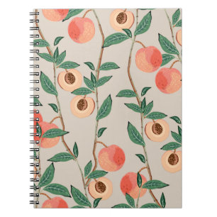 Peach tree branches with leaves and fruits on a li notebook