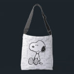 PEANUTS | Snoopy on Black White Comics Crossbody Bag<br><div class="desc">This Peanuts artwork features Snoopy sitting on background of black and white Charles M. Schulz comic strips.</div>