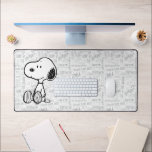 PEANUTS | Snoopy on Black White Comics Desk Mat<br><div class="desc">This Peanuts artwork features Snoopy sitting on background of black and white Charles M. Schulz comic strips.</div>