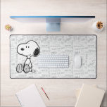 PEANUTS | Snoopy on Black White Comics Desk Mat<br><div class="desc">This Peanuts artwork features Snoopy sitting on background of black and white Charles M. Schulz comic strips.</div>