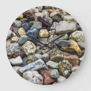 Pebbles on a beach wall clock