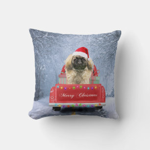 Pekingese Dog in Snow sitting in Christmas Truck Cushion