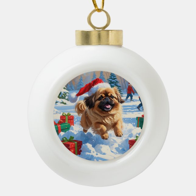 Pekingese Dog Running in Snow with Christmas Hat Ceramic Ball Christmas Ornament (Front)