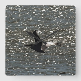Pelican Flying Over Shimmering Lake Bafa Square Wall Clock