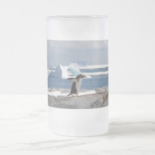 Penguin in front of an ice arch frosted glass beer mug