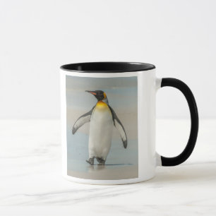 Penguin walking on the beach mug