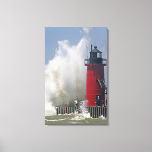People on jetty watch large breaking waves in canvas print