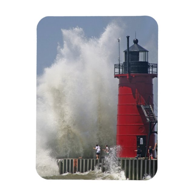 People on jetty watch large breaking waves in magnet (Vertical)