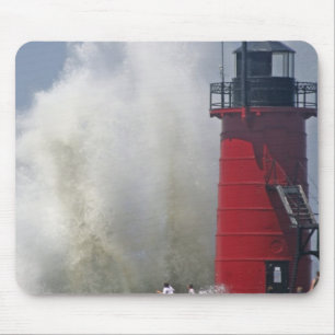 People on jetty watch large breaking waves in mouse mat