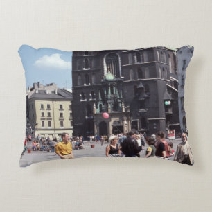 PEOPLE STANDING BESIDE CONCRETE CATHEDRAL DECORATIVE CUSHION