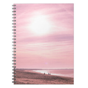 PEOPLE WALKING ALONG SEASHORE DURING GOLDEN HOUR NOTEBOOK