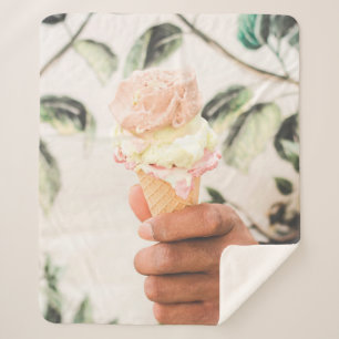 Person holding ice cream cone with three flavours  sherpa blanket