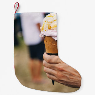 Person holding ice cream on cone small christmas stocking