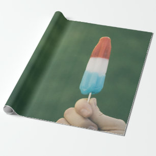 Person holding ice pop wrapping paper