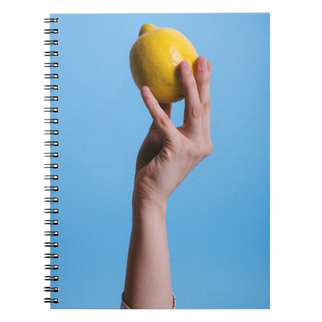 Person holding lemon notebook (Front)