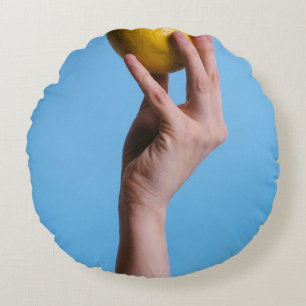 Person holding lemon round cushion
