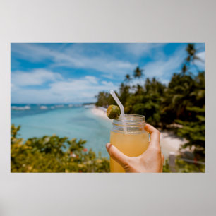 Person holding mason jar with filled with juice at poster