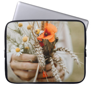 PERSON HOLDING ORANGE PEALED FLOWER LAPTOP SLEEVE