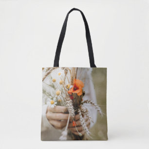 PERSON HOLDING ORANGE PEALED FLOWER TOTE BAG