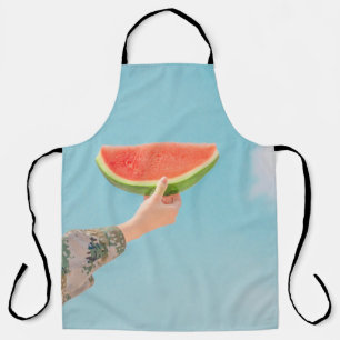 Person holding sliced watermelon apron