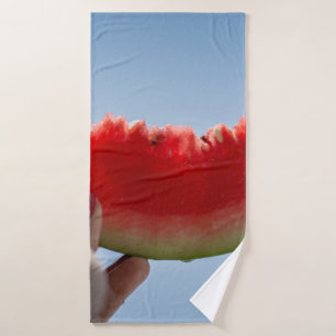 Person holding sliced watermelon bath towel