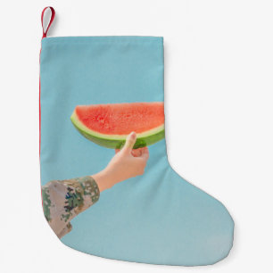 Person holding sliced watermelon small christmas stocking