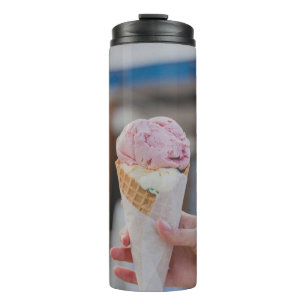 Person holding strawberry ice cream thermal tumbler
