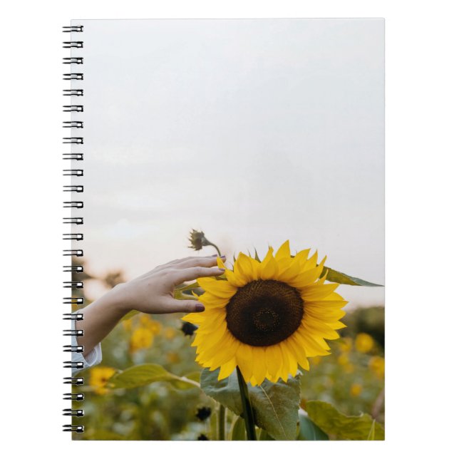 Person holding sunflower notebook (Front)