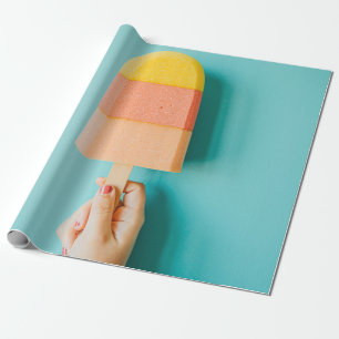 Person holding yellow and brown ice cream cone wrapping paper