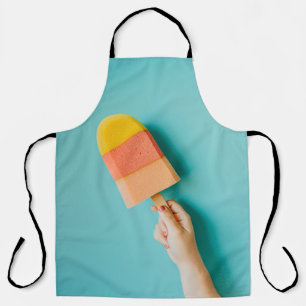 Person holding yellow and pink popsicle apron