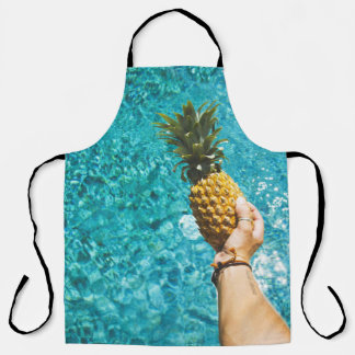 Person holding yellow pineapple apron