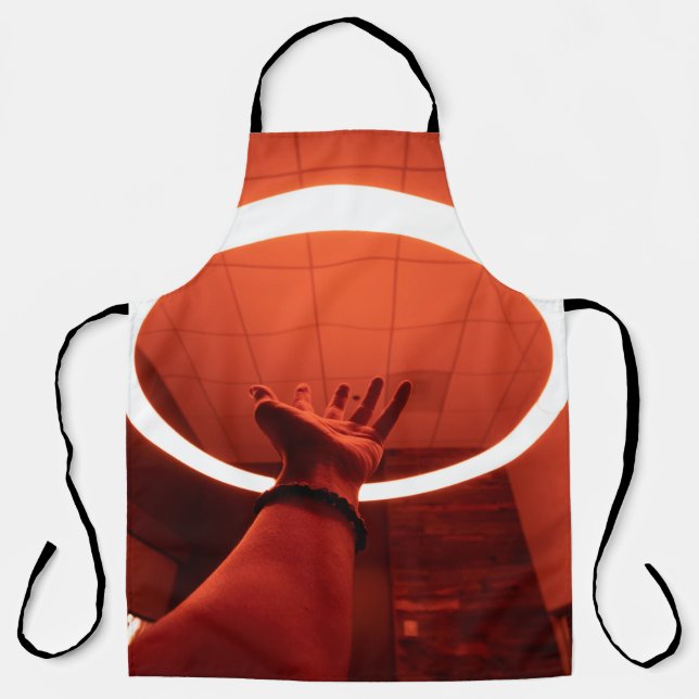 PERSON REACHING ROUND TURNED-ON FLUORESCENT LAMP I APRON (Front)