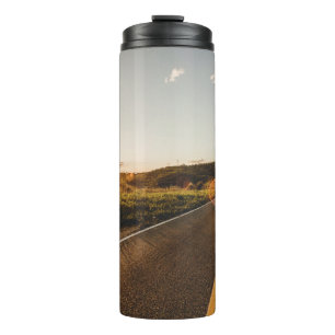 Person running in road in the morning thermal tumbler