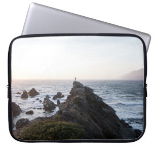 PERSON STANDING ON ROCK CLIFF NEAR BODY OF WATER LAPTOP SLEEVE