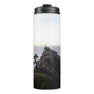 PERSON STANDING ON ROCK CLIFF NEAR BODY OF WATER THERMAL TUMBLER