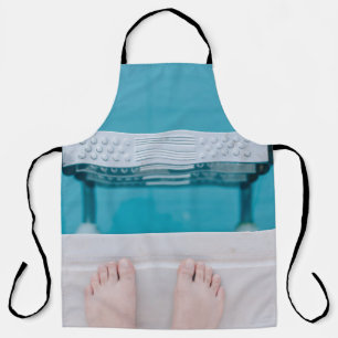 Person standing on swimming pool ladder apron