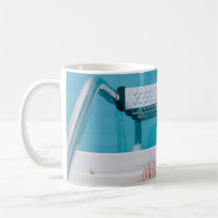 Person standing on swimming pool ladder coffee mug