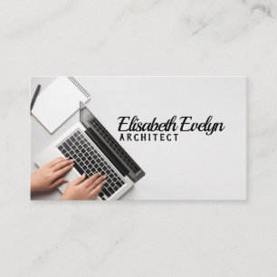 person writing on laptop business card