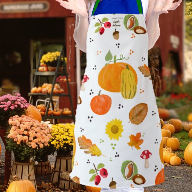 Personalised Autumn Lover Apron (Woman wearing an apron with autumnal pattern in orange, red, green, yellow and brown on white back)