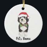 Personalised Bernedoodle Santa Hat & Bowtie Ceramic Tree Decoration<br><div class="desc">I am in love with this beautifully detailed watercolor illustration of a grey, black, and white bernedoodle or sheepadoodle on a an ornament with a sweet little red and green bow tie and santa hat combo! Personalise these ornaments and make the nice list this year! For the perfect presents, pair...</div>