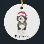Personalised Bernedoodle Santa Hat & Bowtie Ceramic Tree Decoration<br><div class="desc">I am in love with this beautifully detailed watercolor illustration of a grey, black, and white bernedoodle or sheepadoodle on a an ornament with a sweet little red and green bow tie and santa hat combo! Personalise these ornaments and make the nice list this year! For the perfect presents, pair...</div>