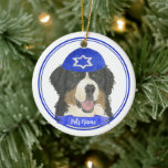 Personalised Bernese Mountain Dog Hanukkah Blue Ceramic Tree Decoration<br><div class="desc">Celebrate your favourite mensch on a bench with personalised ornament! This design features a sweet illustration of a Bernese Mountain Dog with a blue and white yarmulke. For the most thoughtful gifts, pair it with another item from my collection! To see more work and learn about this artist, visit her...</div>